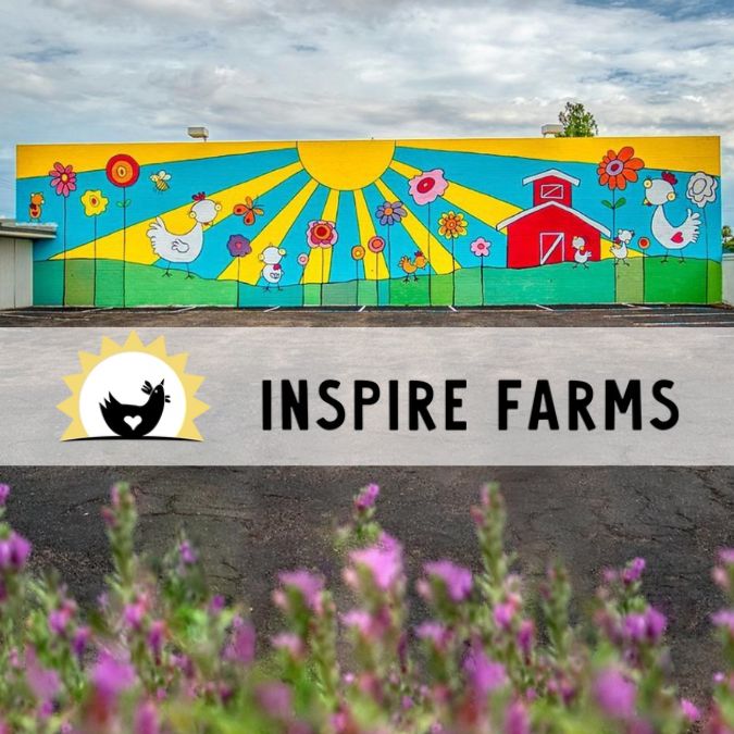 inspire farms logo in front of farm