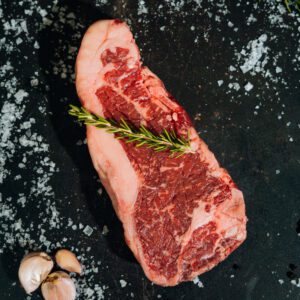 cut of new york strip steak on slate