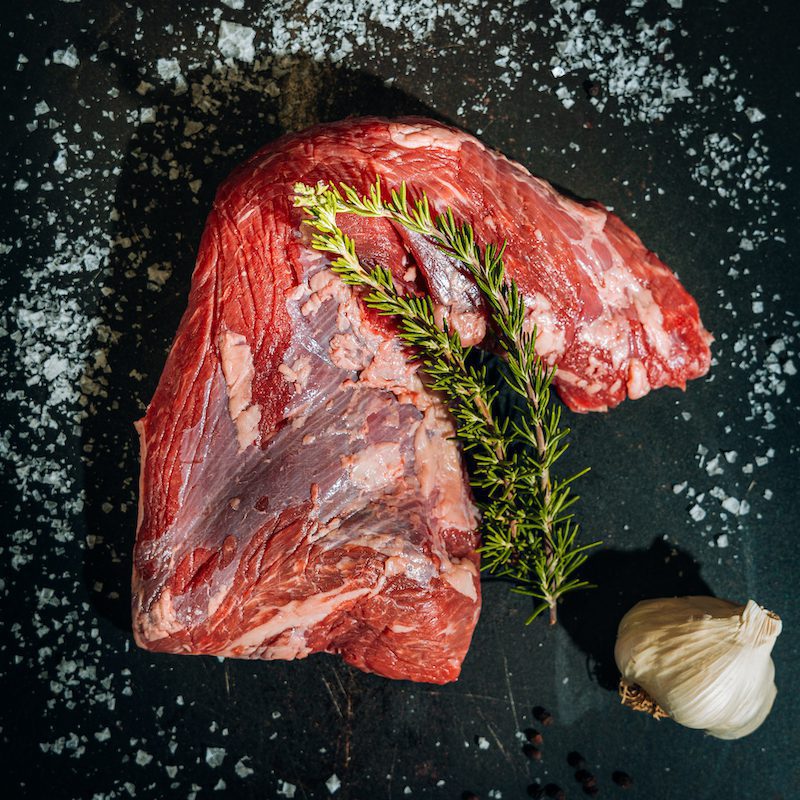 raw cut of tri tip beef on slate